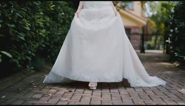 Load video: video of wedding dress with all over lace and beading and detachable sleeves